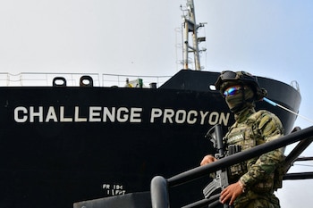 A member of the Mexican Navy stands in front of the petroleum tanker Challenge Procyon, seized by authorities in the Port of Tampico after arriving from the U.S. under suspicion of involvement in the illicit trade of fuels, with nearly 63,000 barrels of diesel, according to security authorities, in Tampico, Mexico, in this handout photo distributed on March 31, 2025. Secretaria de Marina (SEMAR)/Handout via REUTERS ATTENTION EDITORS - THIS IMAGE HAS BEEN SUPPLIED BY A THIRD PARTY. NO RESALES. NO ARCHIVES. BEST QUALITY AVAILABLE
